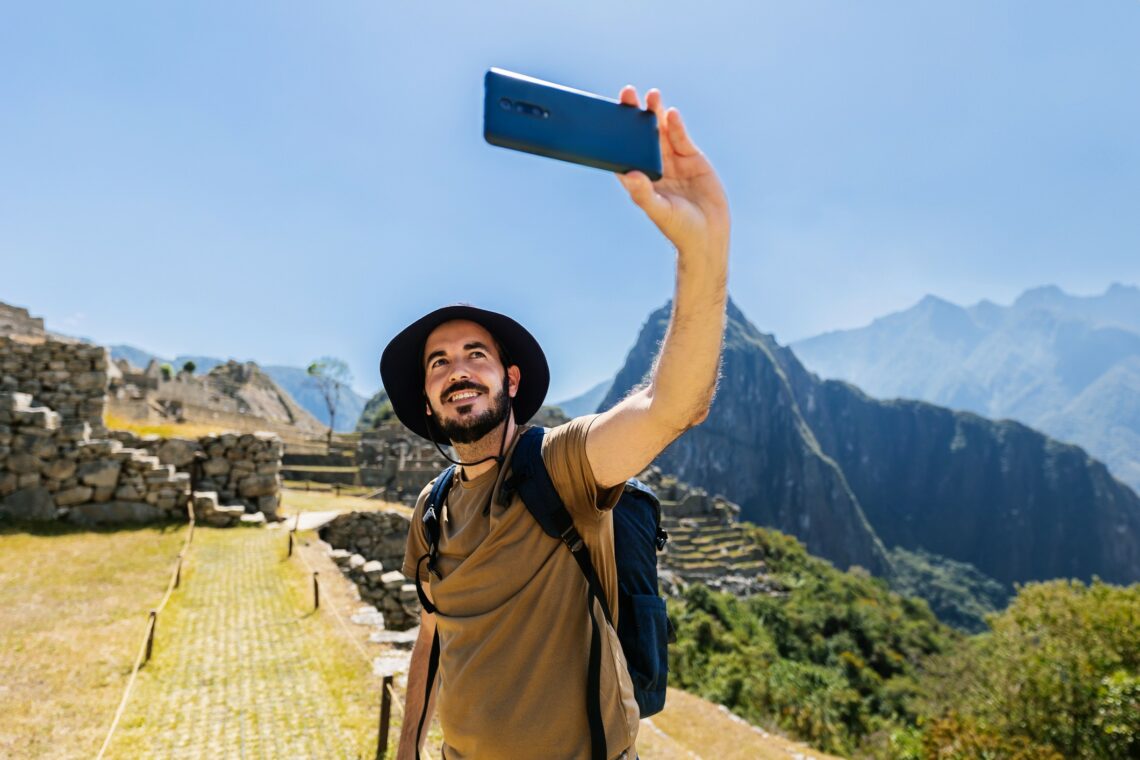 Traveler taking a scenic photo in Barranco, Cusco, and Santiago’s iconic locations.