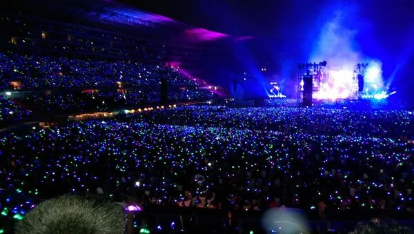 Concert crowd in Lima in 2026 near a large venue