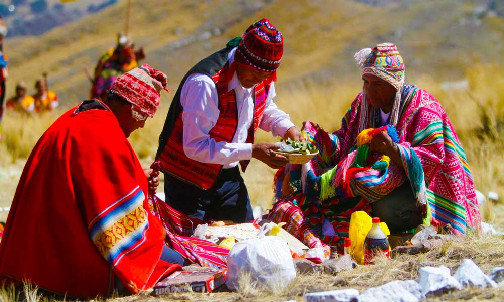 Pachamama ceremony in Cusco with travelers and local guide.