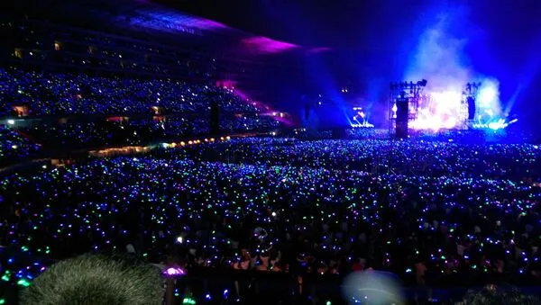 Concert crowd in Lima in 2026 near a large venue