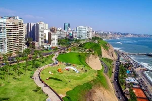 Traveler enjoying lush parks and green spaces in Miraflores, Lima.