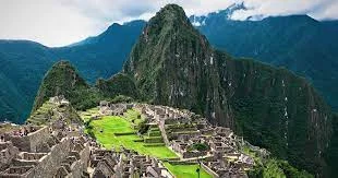 A vibrant view of Machu Picchu surrounded by lush green mountains during February